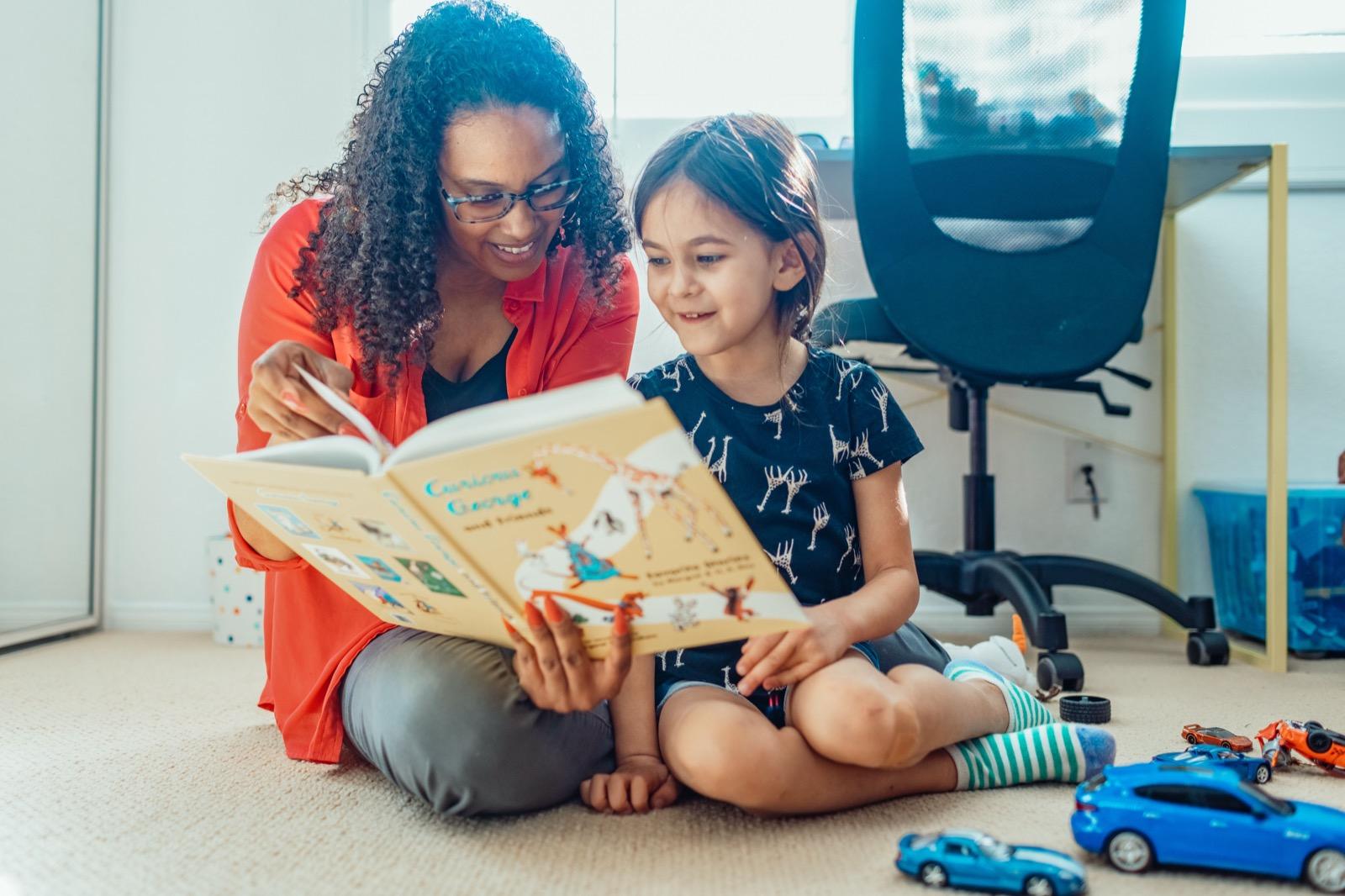 A father reading a picture book with his young child